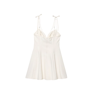 Detail of white mini camisole dress featuring bow tie straps and hidden back zipper closure