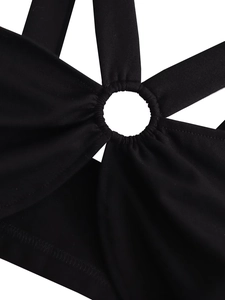 Detail of black halter top featuring a central O-ring and crisscross strap design