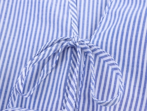 Macro shot of blue and white striped fabric showing detailed tie-up bow craftsmanship