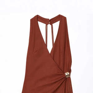 Elegant brick red halter dress with deep V-neck and golden buckle detail in front
