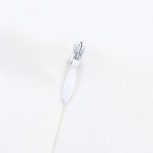 Detailed macro view of an invisible zipper on a white French style summer dress