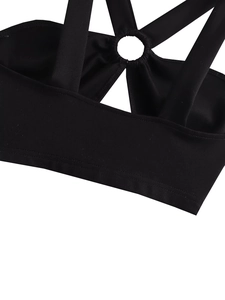 Detail of cross straps and metal ring connector on black slim fit halter top