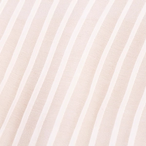 Women loose blouse in beige stripe fabric with delicate vertical pattern and soft texture