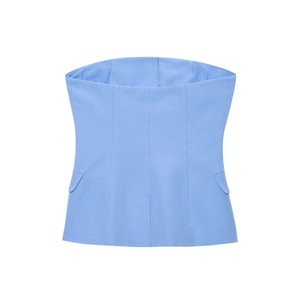 Detail of light blue strapless top featuring decorative pocket flaps and corset stitching