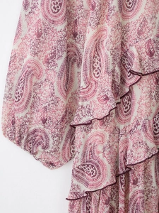 Detail of bohemian paisley print on women's tiered chiffon dress with lantern sleeves