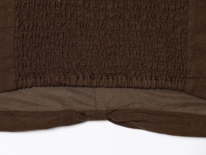 Detail of dark brown smocked fabric texture with elastic pleated smocking craftsmanship