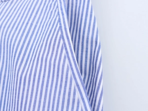 Macro detail of blue and white striped fabric showing high-quality stitching and texture