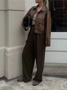 Detail of vintage brown faux leather jacket with large utility pockets and turn-down collar