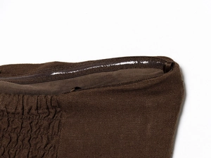 Close-up of brown strapless top showing anti-slip silicone grip and ruched fabric detail