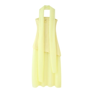 Macro view of light yellow halter dress featuring delicate chiffon fabric and scarf neckline