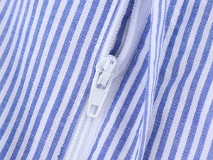Detail shot of the high-quality invisible zipper on a blue and white striped dress
