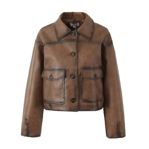 Close-up of vintage brown faux leather jacket collar and symmetrical flap pockets