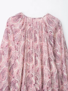 Detail of bohemian paisley print dress with pleated neckline and soft chiffon fabric texture