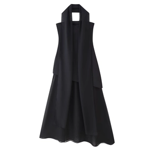 Detail of elegant black halter dress featuring tiered chiffon fabric and chic neck tie