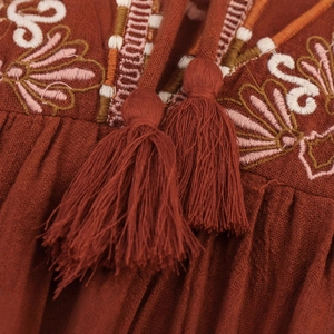 Relaxed bohemian embroidered dress in brick red with tassel neck ties and ethnic detail