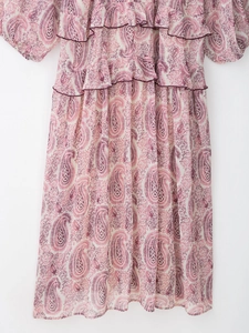 Detail of floral paisley print dress with layered ruffle collar and high waist design