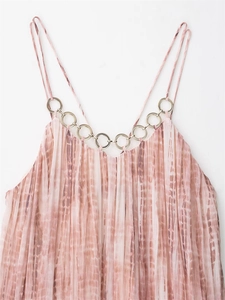 Detail of pink tie-dye pleated dress with metal ring hardware and thin straps