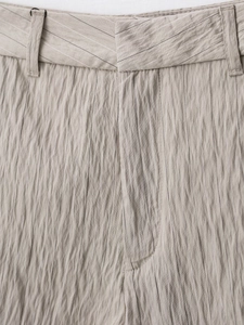 Detail of beige striped fabric texture and stitching on french style shorts for women