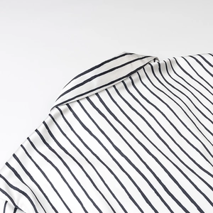 Close-up of elegant striped satin shirt showing high-quality fabric texture and collar detail