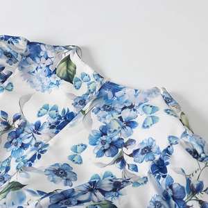 Detailed close-up of blue floral hydrangea and butterfly print on a white crew neckline