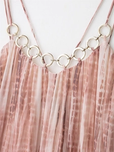 Detailed close-up of pink tie-dye pleated fabric with gold metal ring neckline detail