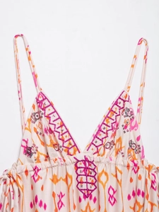 Detail of bohemian camisole showing purple embroidery and sequins on ethnic floral print