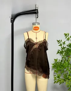 Detail shot of a chocolate brown silk camisole featuring intricate lace trim on the hem