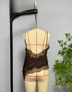 Detail of dark brown satin dress with floral lace trim and asymmetrical hemline