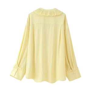 Élégante blouse jaune clair à manches longues avec col plissé et détails aux poignets