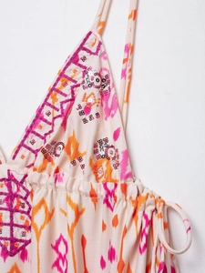 Detail of floral ikat print top featuring purple geometric embroidery and silver sequins