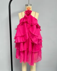 Detail of pink tiered ruffle mini dress with halter neck and 3D floral accent