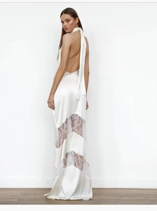 Detail of white satin halter dress with lace patchwork and elegant open back design