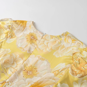 Close-up of the yellow floral dress back neckline with a discreet invisible zipper detail