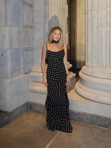 Detailed view of the layered ruffled hem and polka dot pattern on the elegant maxi dress