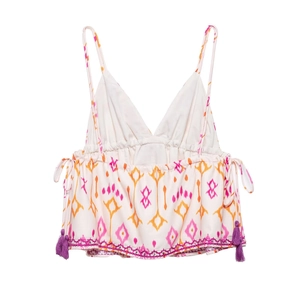 Detail of V-neck crop top with ethnic embroidery patterns and purple tassel trim