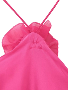 Detail of deep pink ruffled dress featuring thin double straps and textured fabric pleats