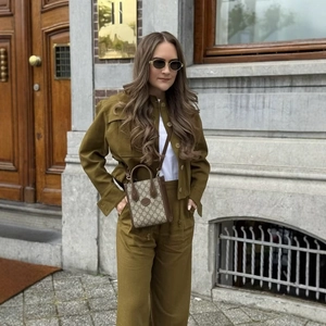 Fashionable olive green drawstring jacket set with a classic patterned mini tote bag