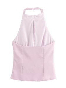 Detail of light pink halter top featuring pleated front design and smooth fabric texture