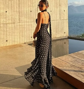 Detail of layered ruffle fishtail hem and polka dot fabric on an elegant long dress
