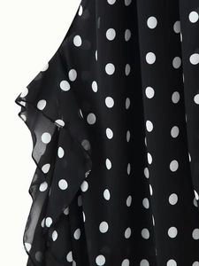 Detailed close-up of white polka dot chiffon fabric with elegant ruffle edge finish