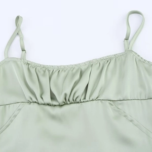 Pale green satin camisole featuring a ruched chest design and adjustable spaghetti straps