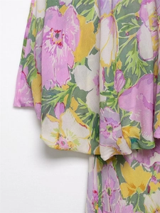 Close-up of fresh floral print details on high-quality fabric of a summer dress