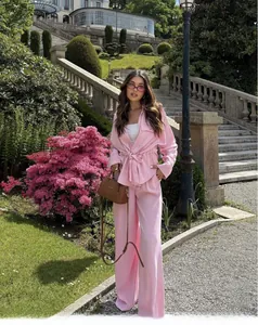 Detail view of pink safari style two-piece set with belted waist shirt and wide leg trousers