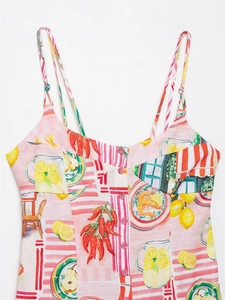 Detail of pink floral spaghetti strap top with lemon and chili Mediterranean print