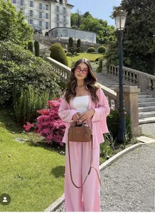 Detailed full-body view of the pink safari-style shirt and wide-leg trousers set