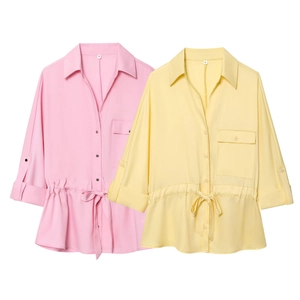 Detail of short sleeve safari style shirts with chest pockets and drawstring waist ties