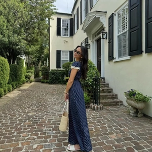 Navy blue polka dot maxi dress with lace sleeves and chic vintage vacation styling