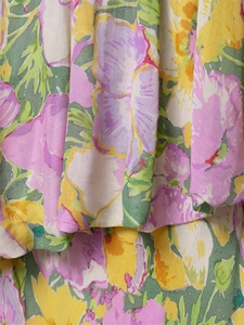 Detailed macro view of vibrant floral print on textured cotton-linen summer dress fabric
