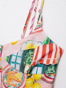 Detail of floral print maxi dress featuring lemon and shrimp motifs with striped straps
