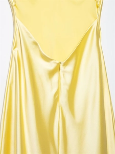 Detail of bright yellow satin midi dress featuring a deep V back and hidden zipper
